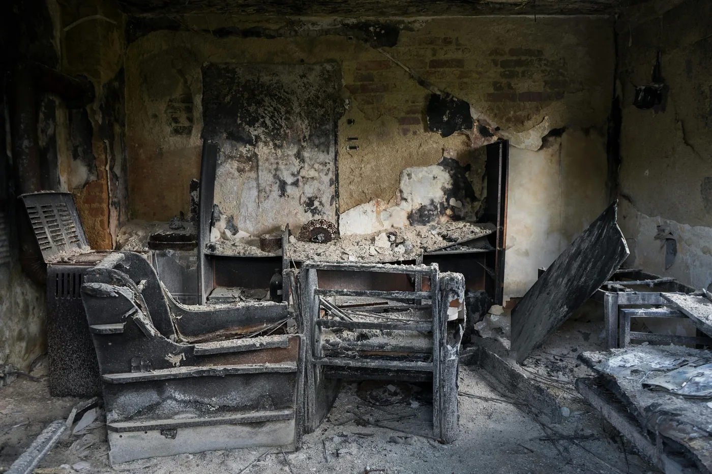 fire damage restoration boise idaho — charred room being assessed by restoration technician